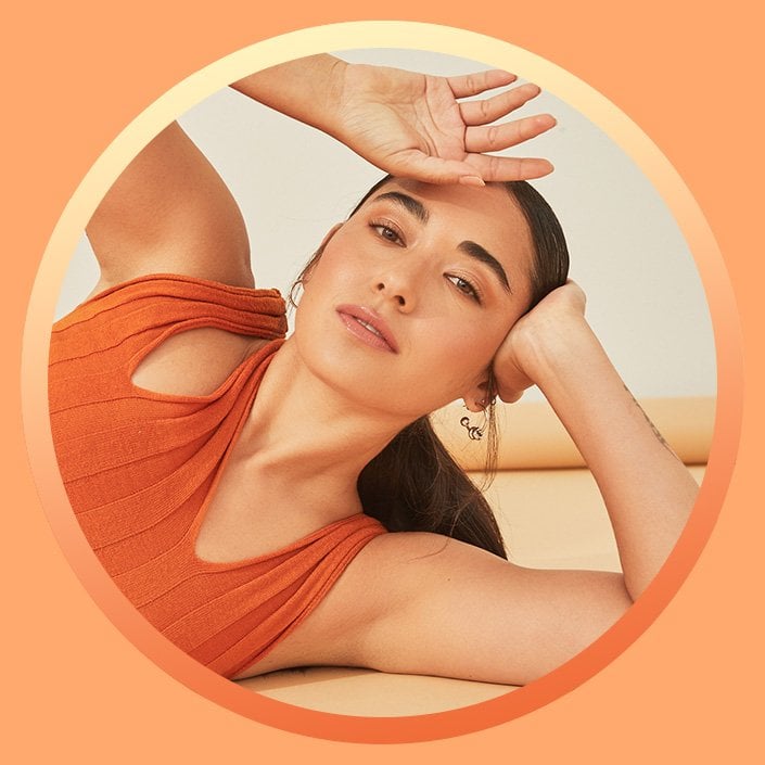 Model with back of hand against forehead
