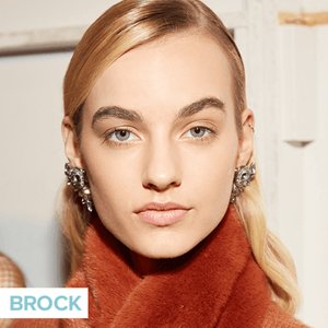 person wearing neutral makeup and slicked hair