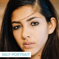 person wearing dark eye makeup
