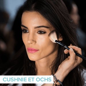 person applying makeup to someone else's cheekbone