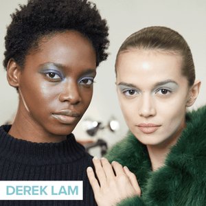 two people looking into camera and posing wearing metallic eye makeup