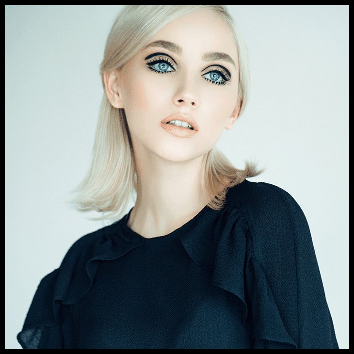person with blonde hair wearing black graphic eye makeup