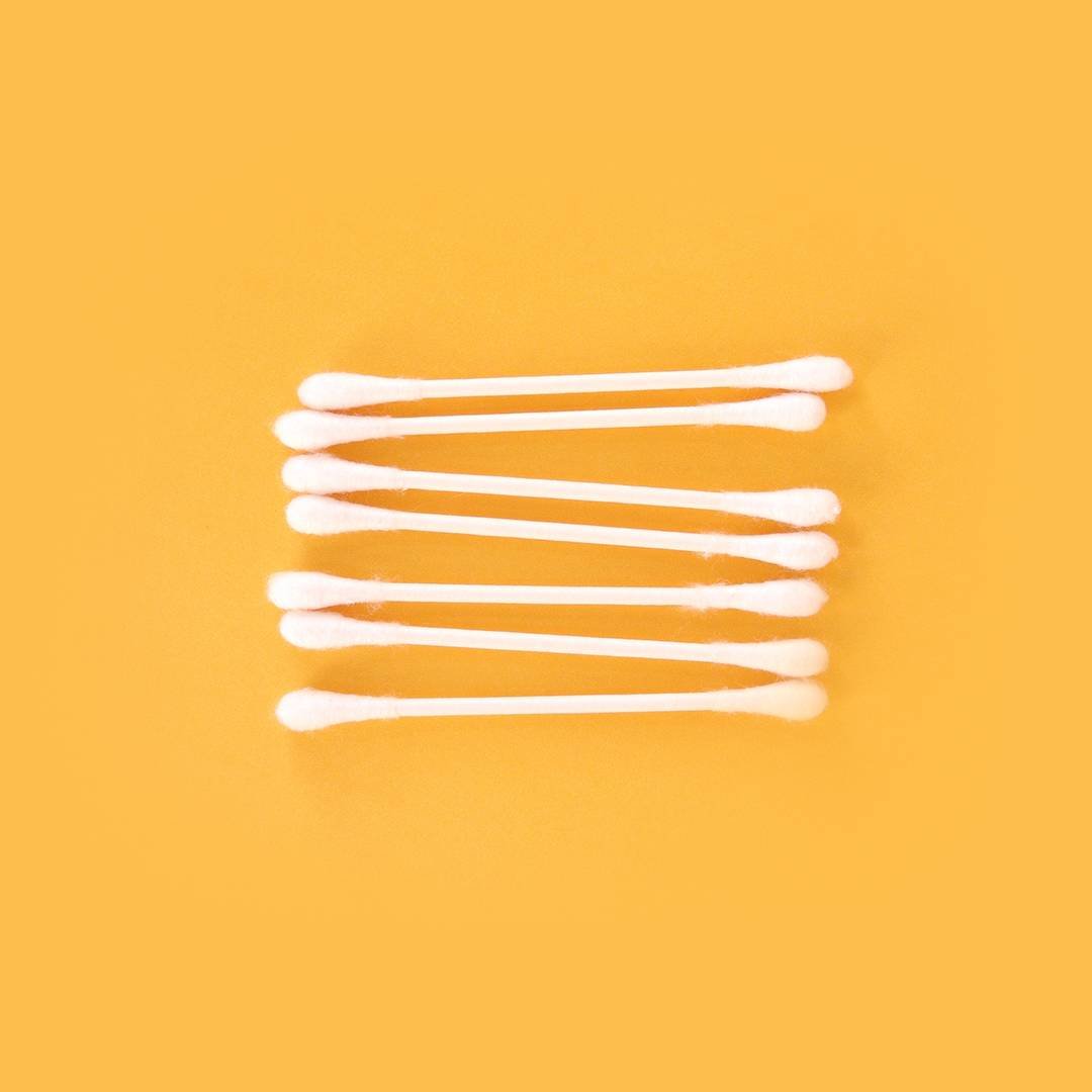 q-tips on orange background