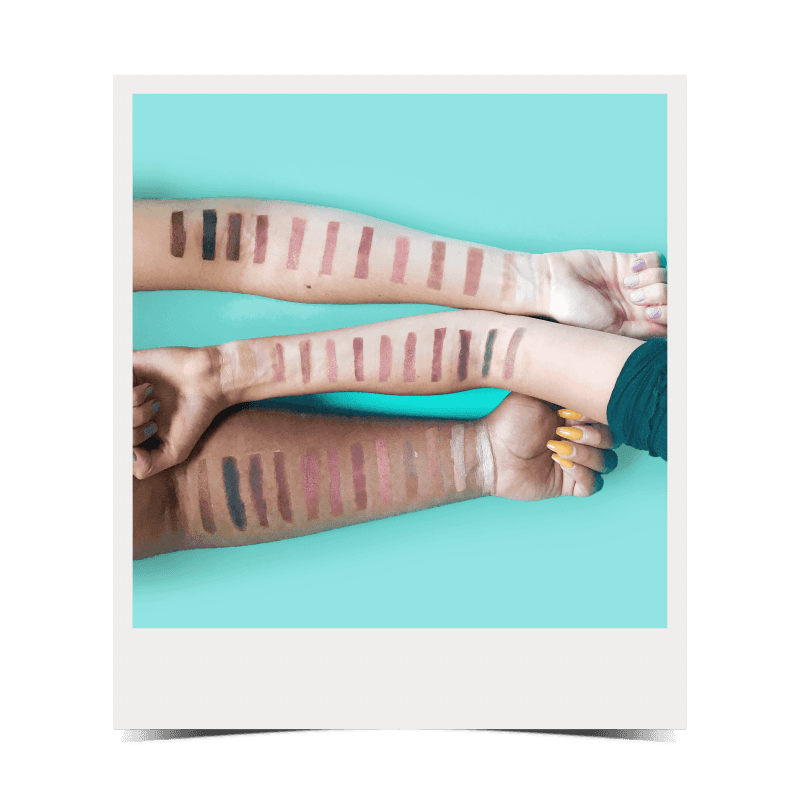 arms with eyeshadow swatches on them