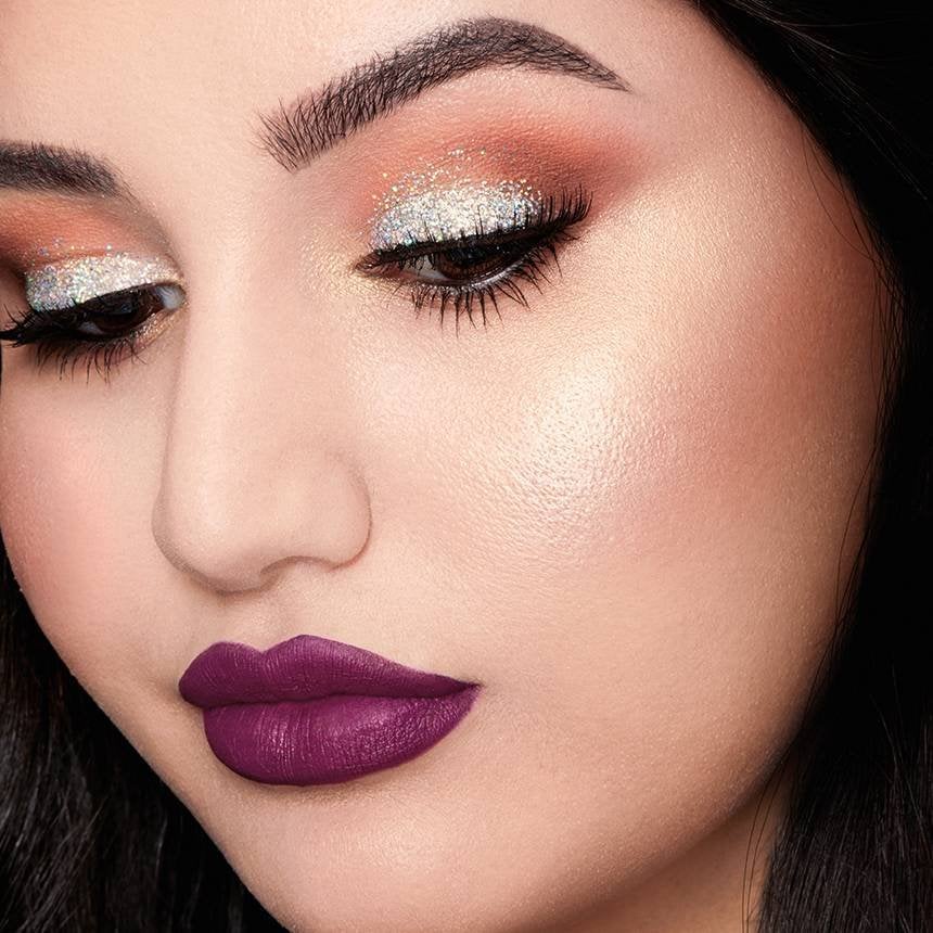 person wearing white glitter eyeshadow and purple lipstick