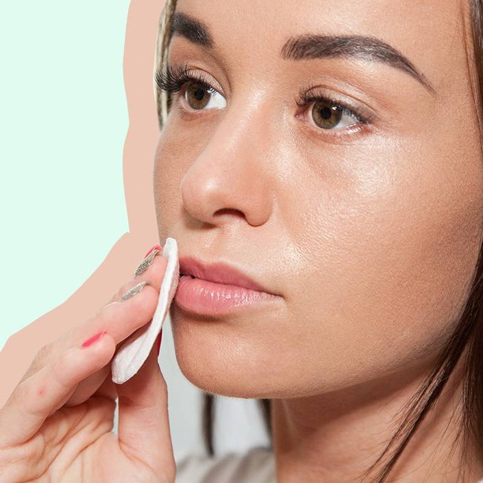 person holding cotton pad to lips