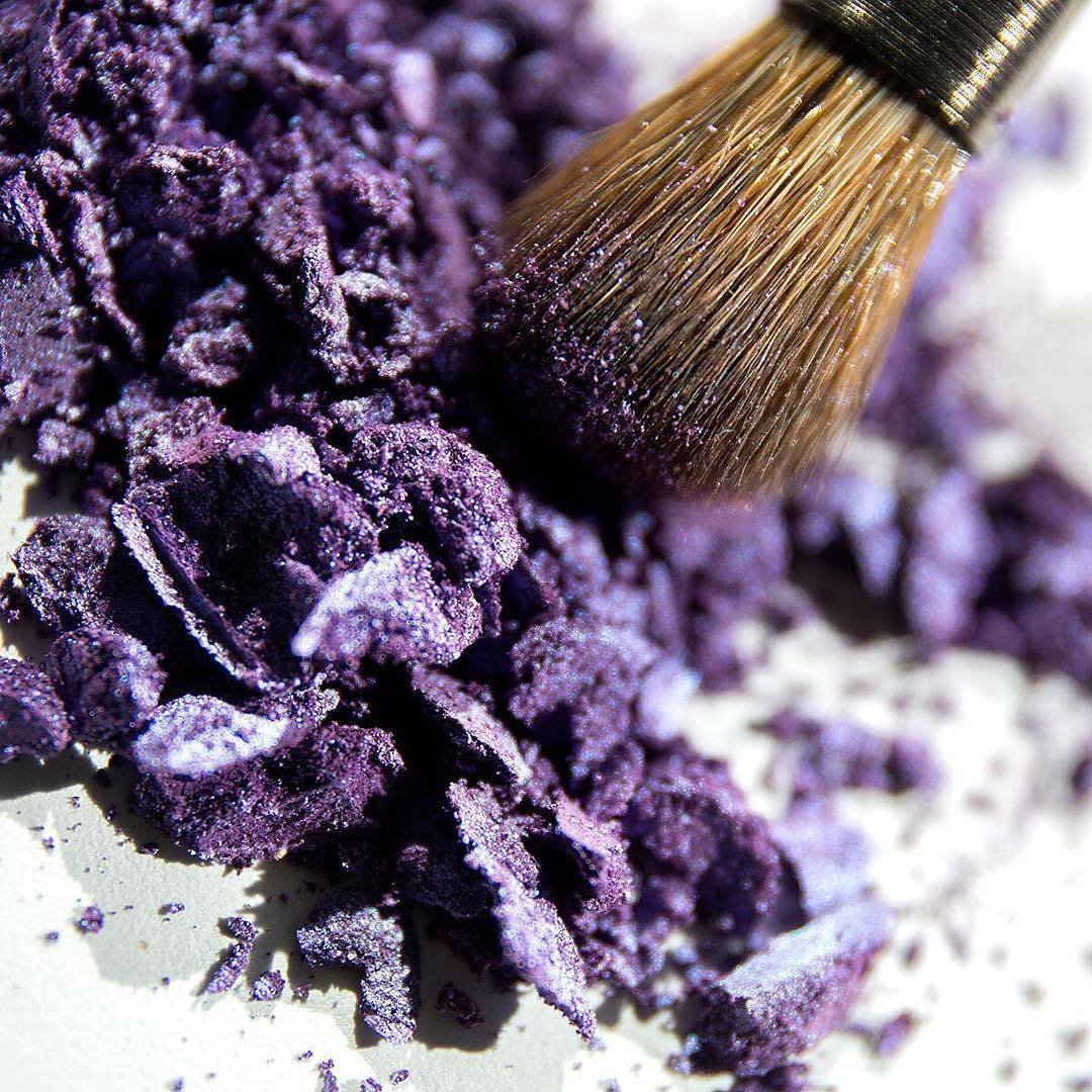 makeup brush in broken purple eyeshadow