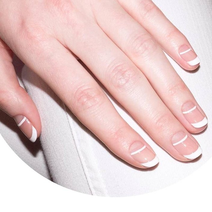 hand with white double french manicure on nails