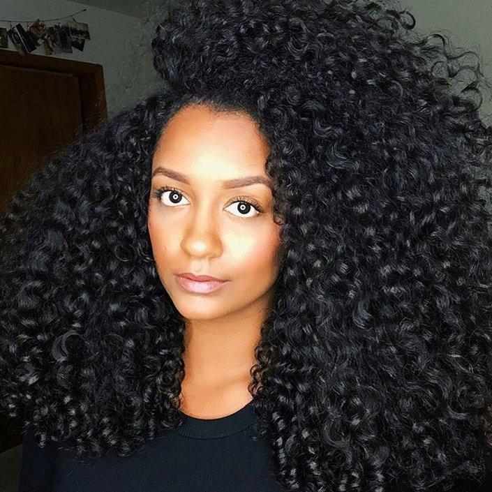person with black long naturally curly hair