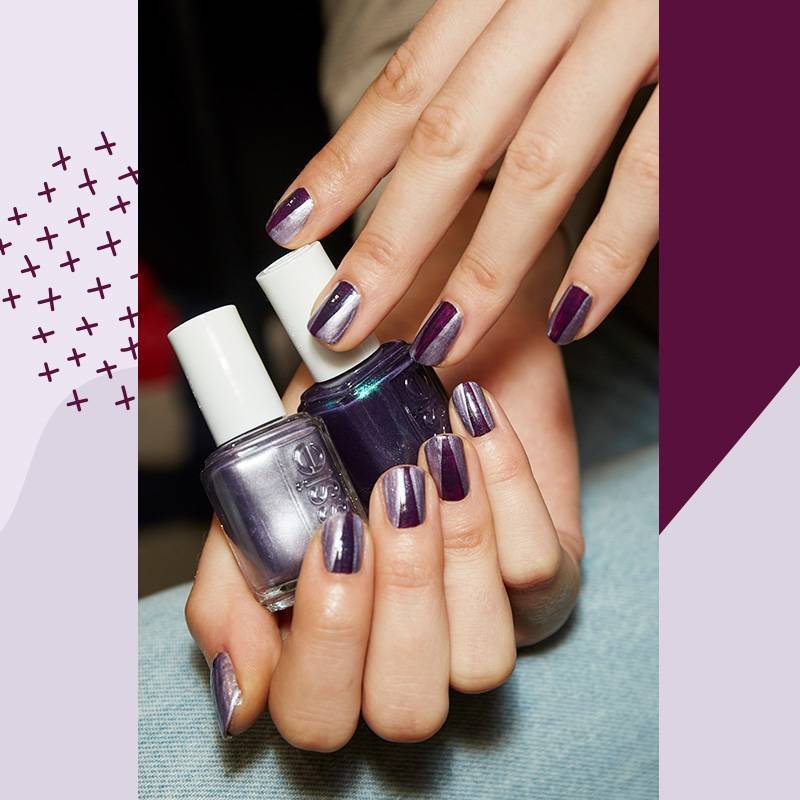 hands with nails polished metallic purple holding metallic purple essie nail polish