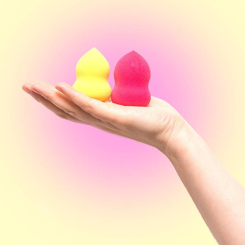 hand holding two makeup sponges