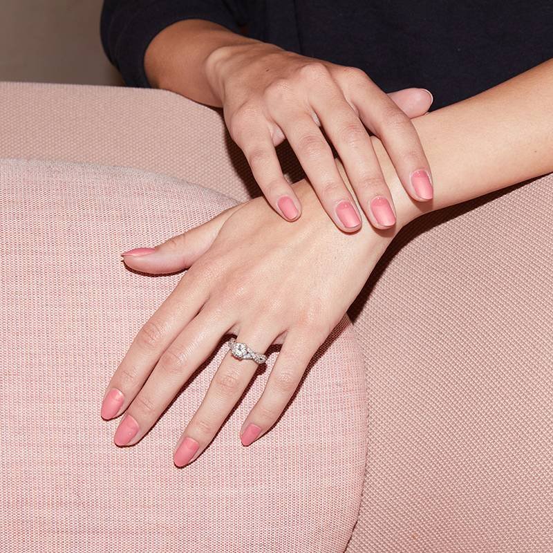 hands with pink reverse french manicure on nails