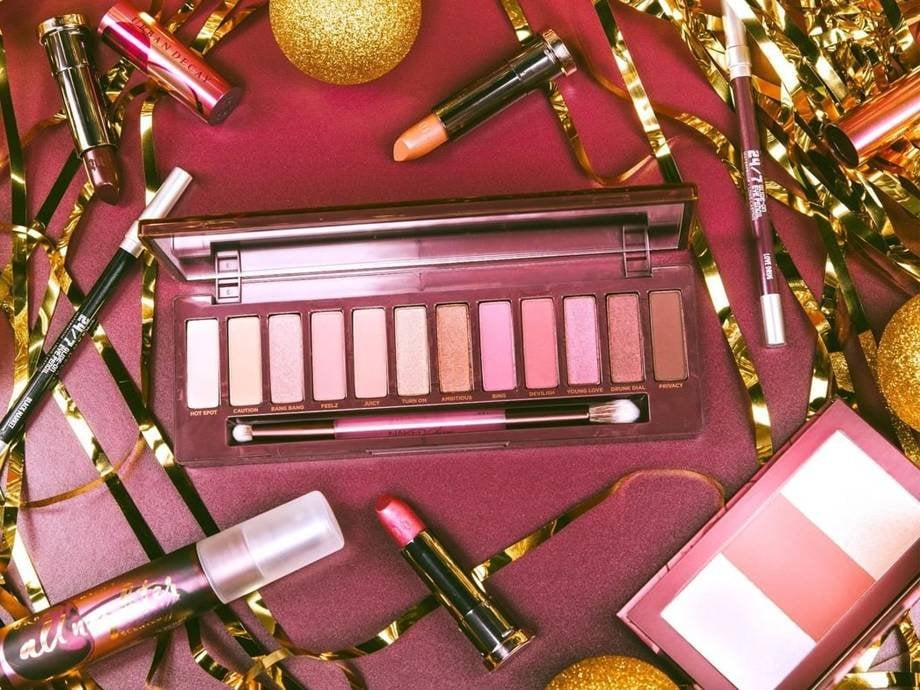 makeup products surrounded by holiday decor