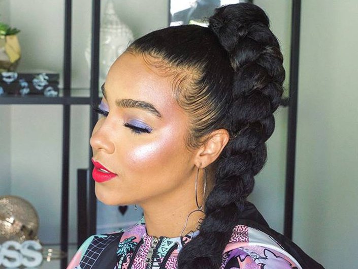 person with natural hair in high ponytail and long braid
