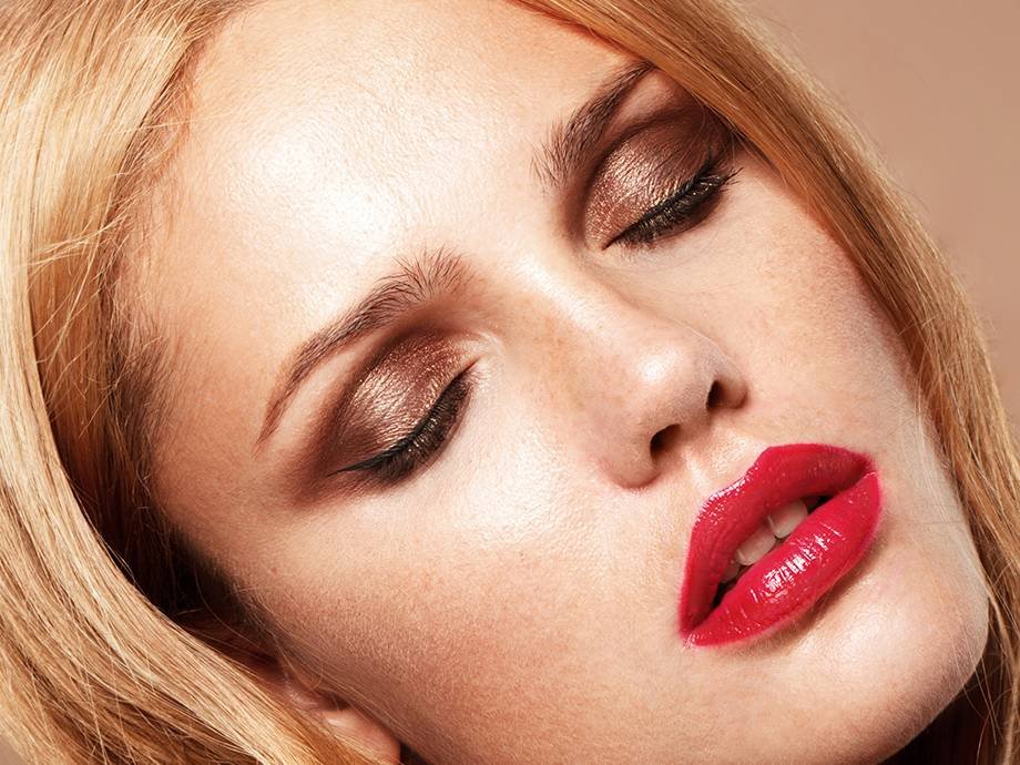 person wearing copper eyeshadow and red lipstick