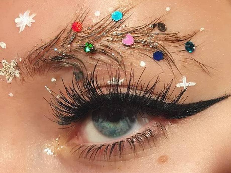 close-up of person's eye wearing christmas tree eyebrows trend
