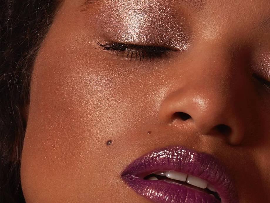 person wearing glitter eyeshadow and purple lipstick