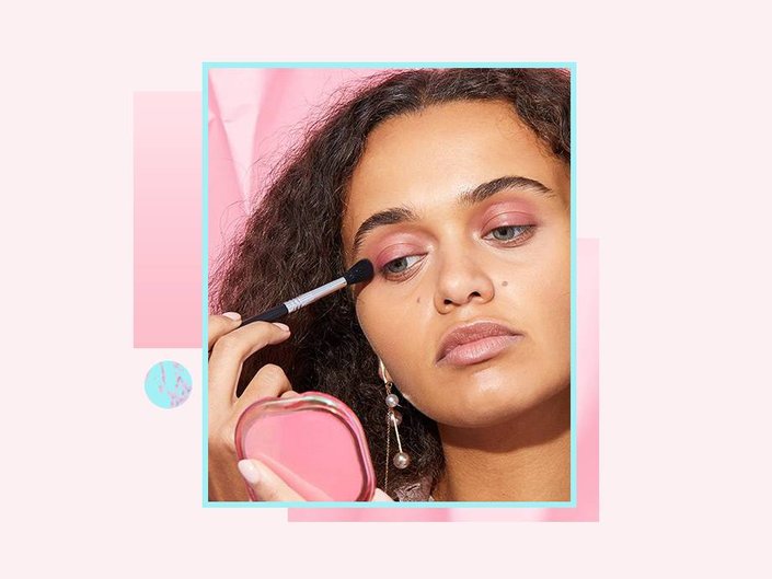 person applying pink eyeshadow