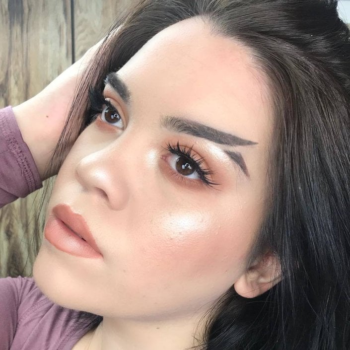 person wearing fishtail eyebrow trend