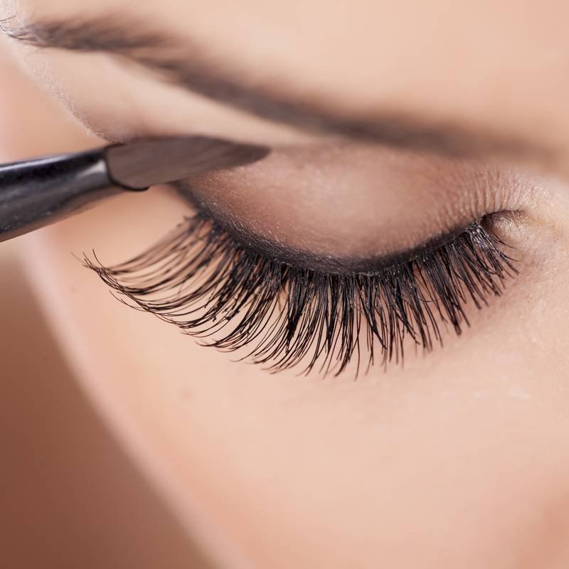 close-up on makeup brush applying eyeshadow to eyelid