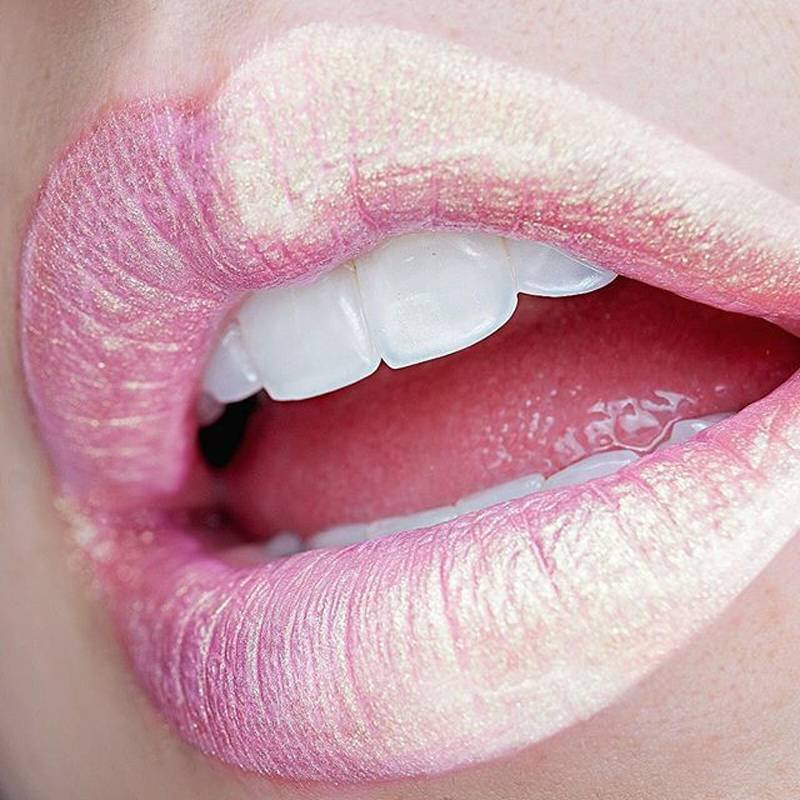 lips wearing pink holographic lipstick