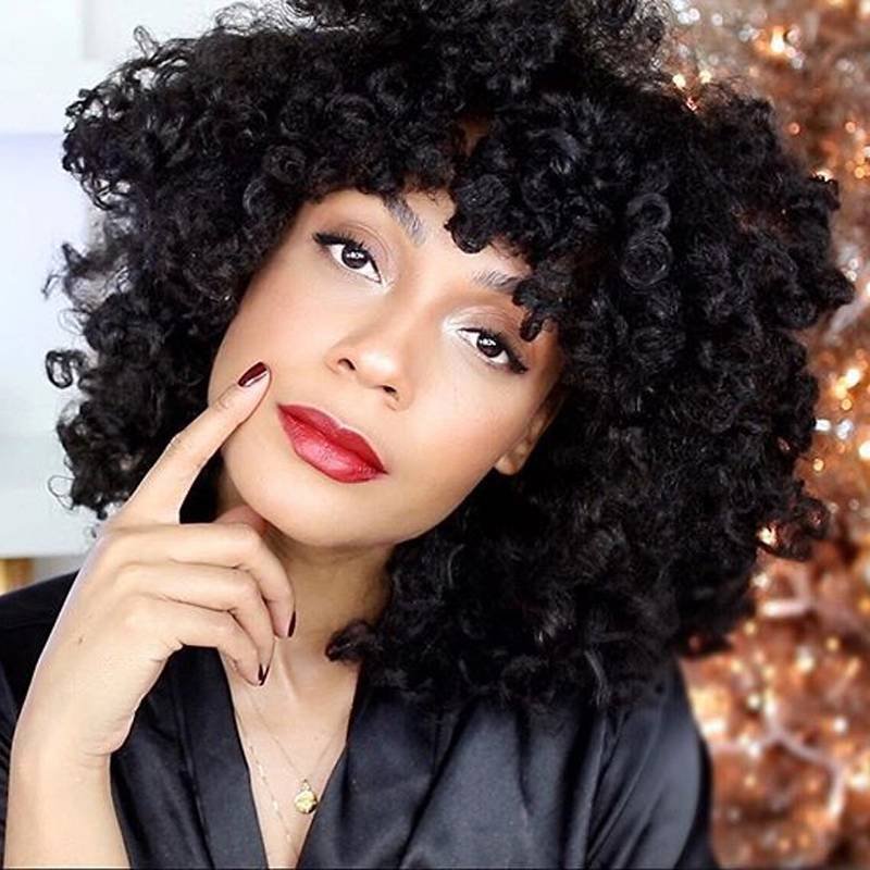 person with naturally curly hair wearing red lipstick