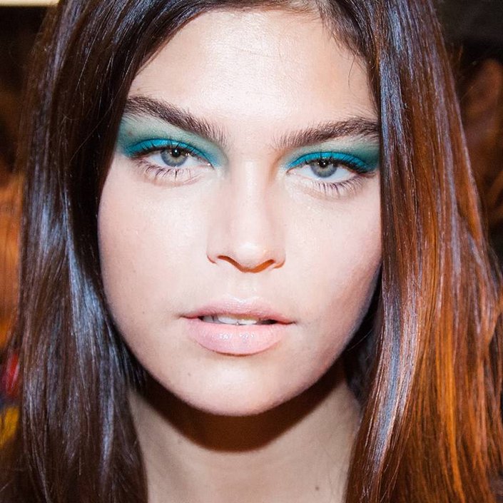 person wearing blue and green eyeshadow