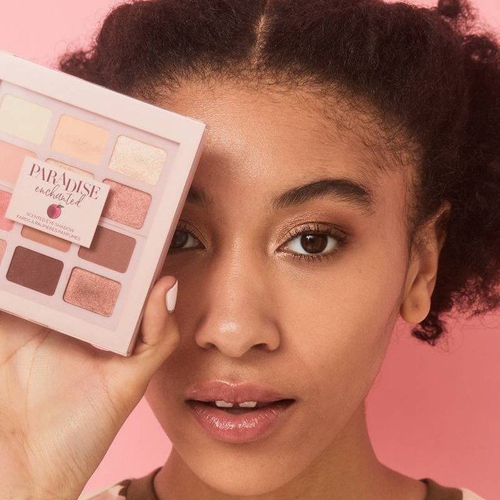 person holding L’Oréal Paris Paradise Enchanted Scented Eyeshadow Palette in front of eye