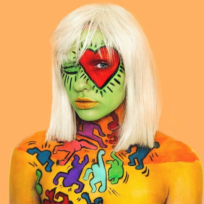 person wearing keith haring inspired face and body makeup