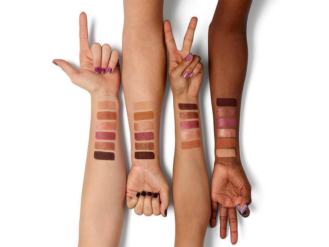 four arms filled with eyeshadow swatches