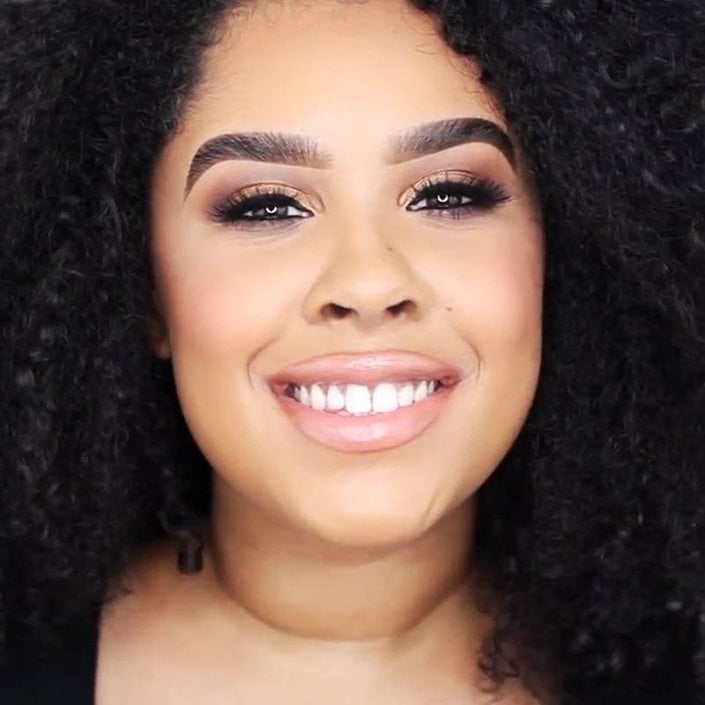 person wearing smokey eyeshadow and nude lipstick