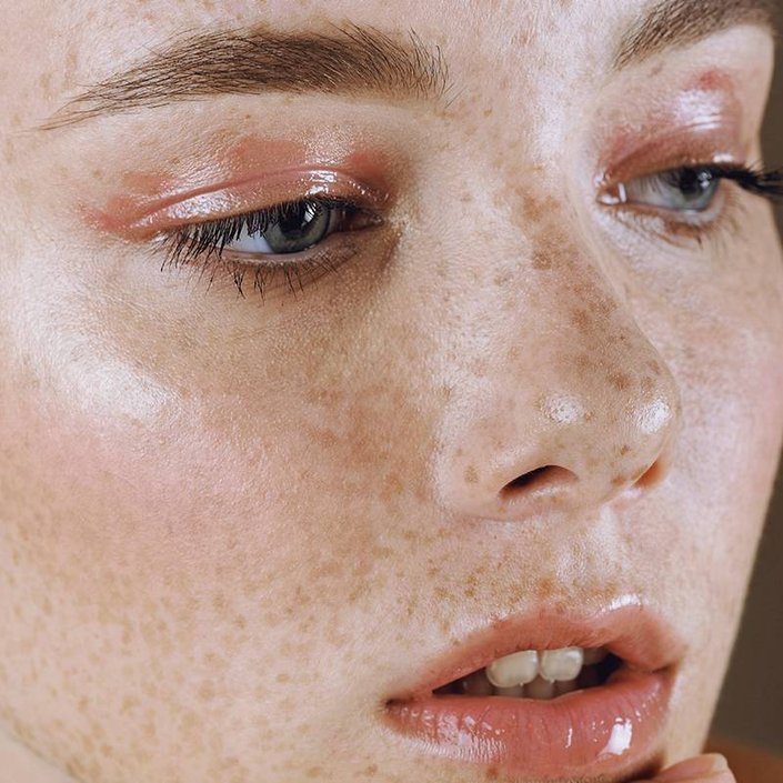 person wearing glossy eyeshadow and lip gloss