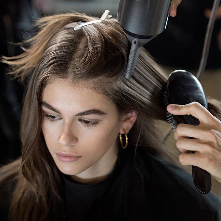 person getting their hair blow dried