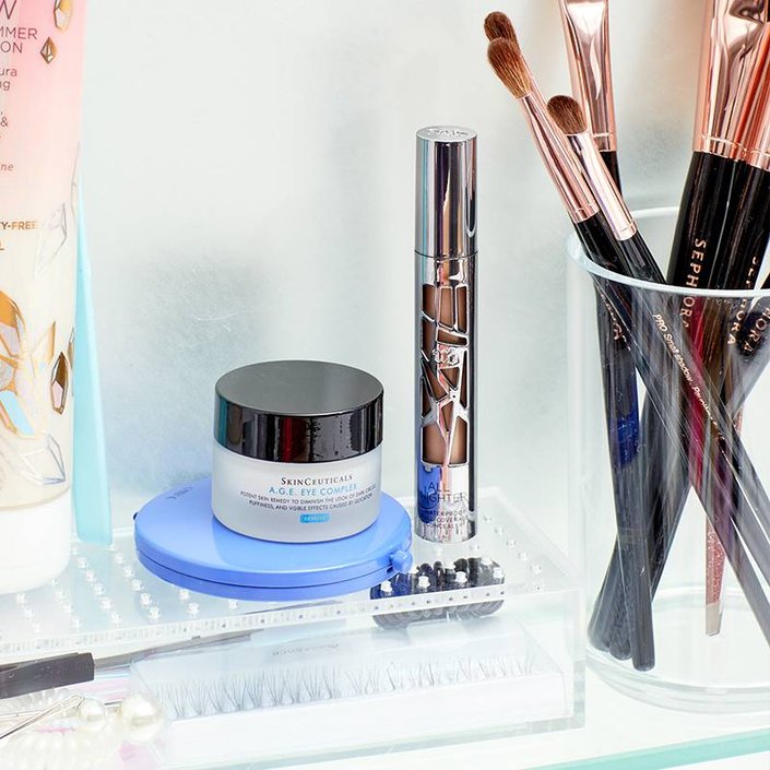 beauty products organized on glass shelf