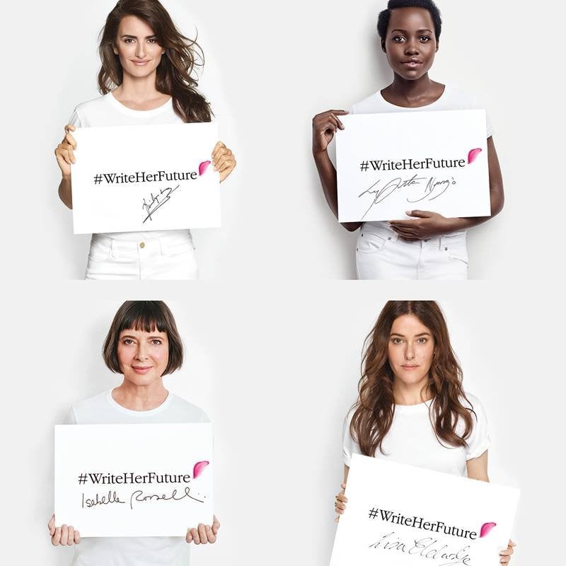 four people wearing all white and holding up a white sign