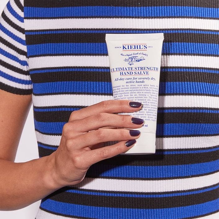 hand holding Kiehl’s Ultimate Strength Hand Salve