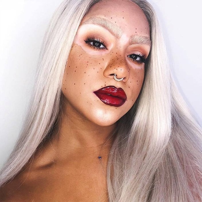 person with vitiligo and silver hair wearing red lipstick
