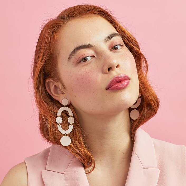 person wearing pink lip and cheek makeup stick