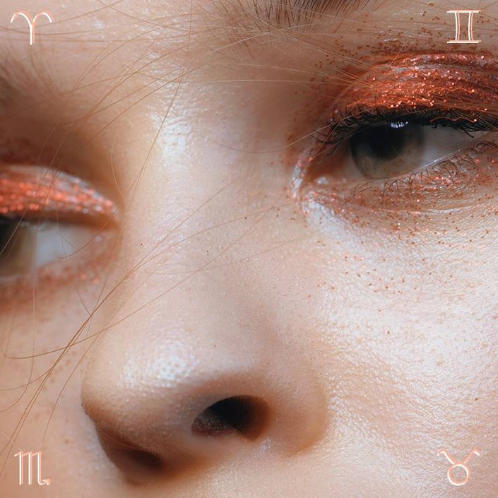 close-up of eyes wearing orange glitter eyeshadow