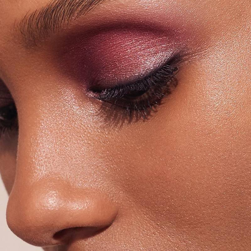 close-up of person's eye wearing red shimmering eyeshadow