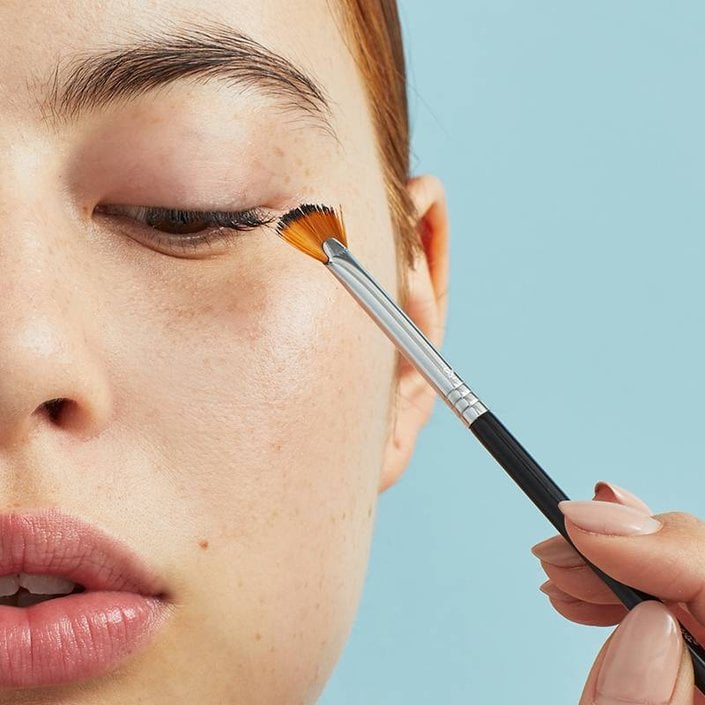 person holding Sigma E04 Lash Brush to eyelashes