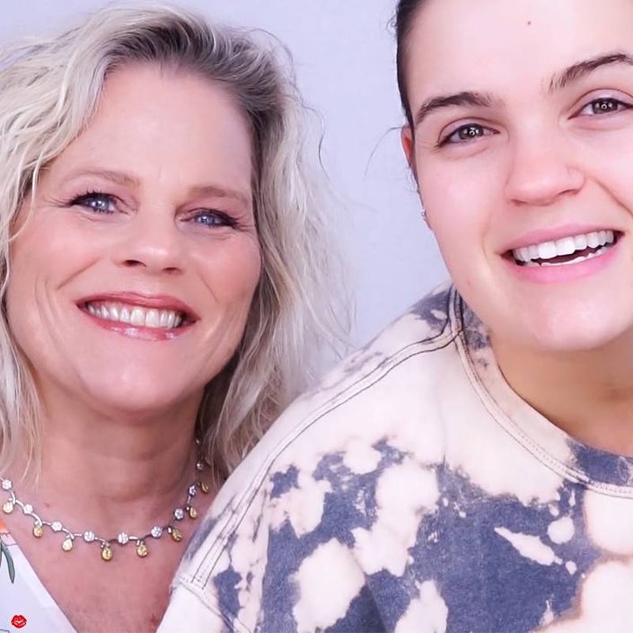 mature person wearing makeup posing next to young person not wearing makeup