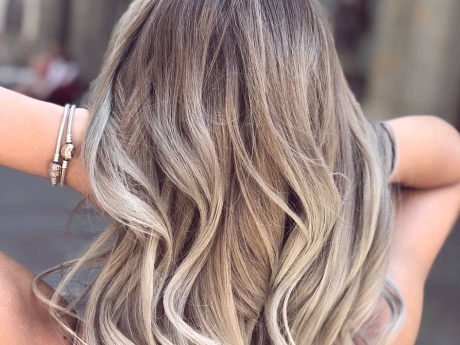 blonde highlighted hair styled in loose curls