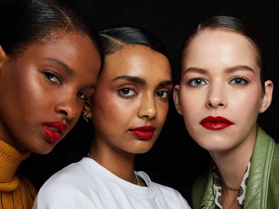 three people with different skin tones wearing red lipstick