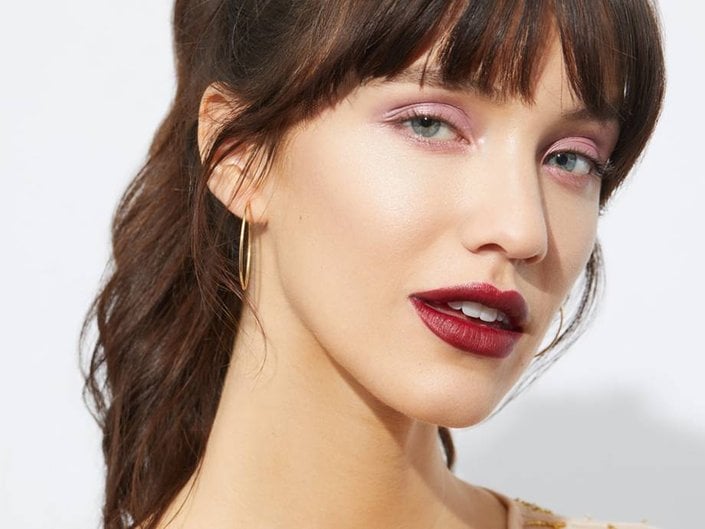person wearing pink eyeshadow and red lipstick