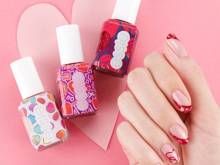 essie valentine's day collection surrounding hand wearing red nail art on nails