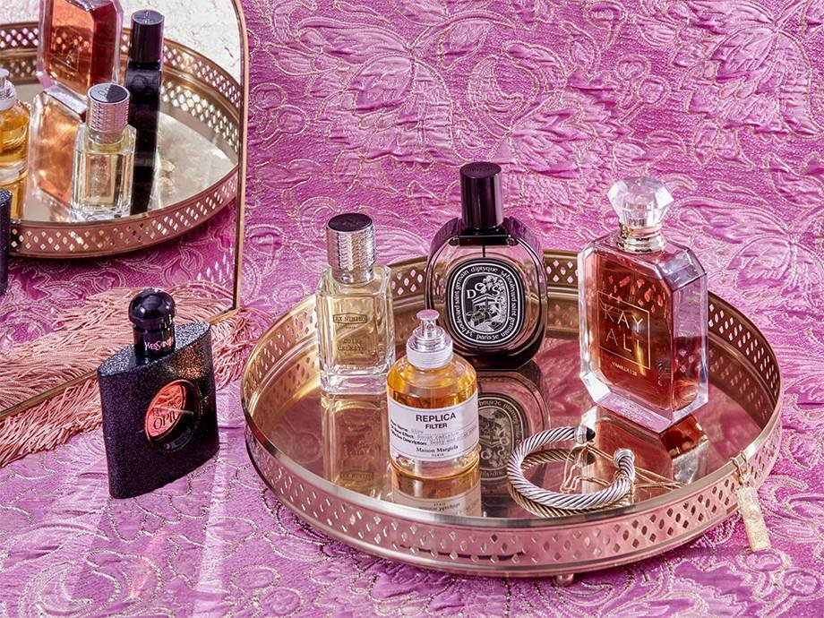 various fragrances on a round gold tray