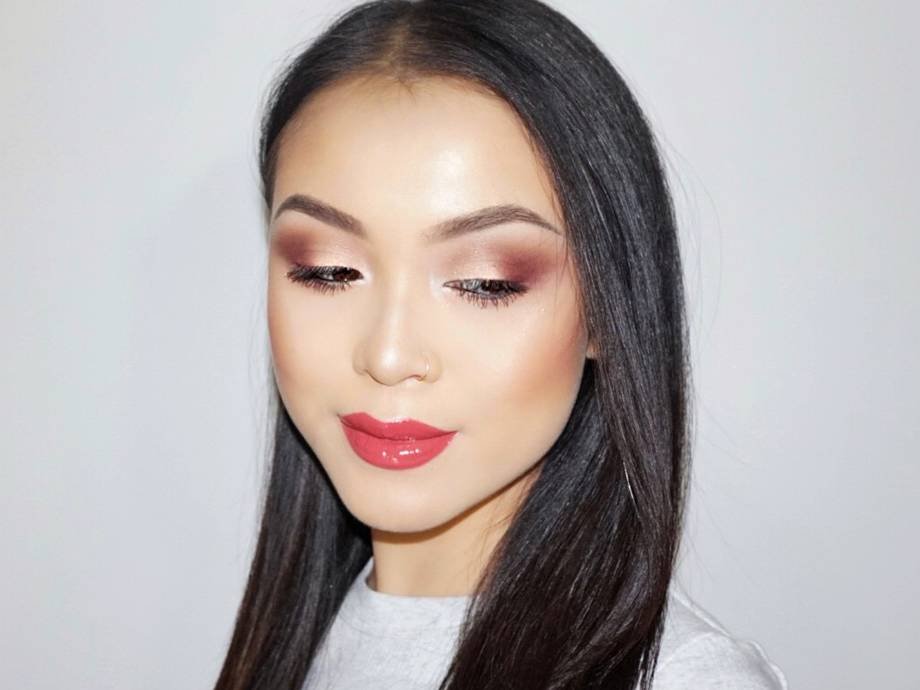 person wearing smokey eyeshadow and glossy lipstick