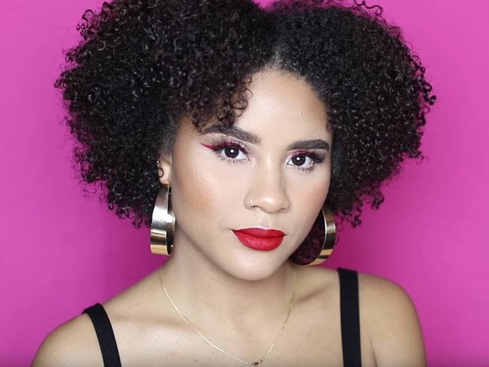 person wearing red lipstick and winged eyeliner