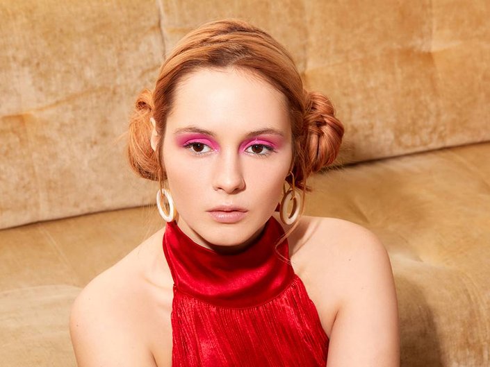 person wearing glossy pink eye makeup